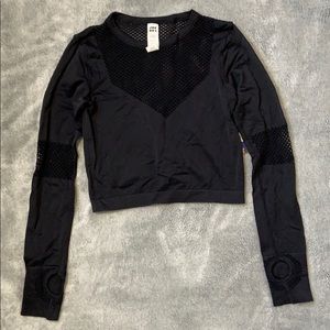 Small mesh crop top with thumb holes.